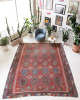 Vintage kilim rug in living room setting, old rug, antique rug, pastel colors, faded colors, Turkish rug, vintage rug, soft rug, Portland, Oregon, rug store, rug shop, local shop, earthy tones, earthy colors, warm colors