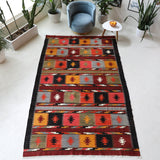 Vintage kilim rug in living room setting, bright colors, wild shaman, soft rug, bold color, Portland, Oregon, rug store, rug shop, local shop, vintage rug, modern kilim, warm colors