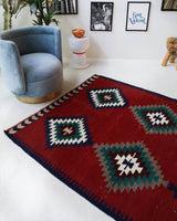 Vintage kilim rug in room decor setting, old rug, antique rug, pastel colors, faded colors, Turkish rug, vintage rug, soft rug, Portland, Oregon, rug store, rug shop, local shop, bold colors, bright colors, faded colors