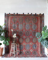 Vintage kilim rug in living room setting, old rug, antique rug, pastel colors, faded colors, Turkish rug, vintage rug, soft rug, Portland, Oregon, rug store, rug shop, local shop, earthy tones, earthy colors, warm colors