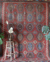 Vintage kilim rug in living room setting, old rug, antique rug, pastel colors, faded colors, Turkish rug, vintage rug, soft rug, Portland, Oregon, rug store, rug shop, local shop, earthy tones, earthy colors, warm colors