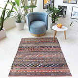 Vintage kilim rug in living room setting, old rug, antique rug, pastel colors, faded colors, Turkish rug, vintage rug, soft rug, Portland, Oregon, rug store, rug shop, local shop, earthy tones, earthy colors, warm colors