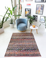 Vintage kilim rug in living room setting, old rug, antique rug, pastel colors, faded colors, Turkish rug, vintage rug, soft rug, Portland, Oregon, rug store, rug shop, local shop, earthy tones, earthy colors, warm colors