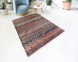 Vintage kilim rug in living room setting, old rug, antique rug, pastel colors, faded colors, Turkish rug, vintage rug, soft rug, Portland, Oregon, rug store, rug shop, local shop, earthy tones, earthy colors, warm colors
