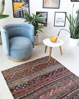 Vintage kilim rug in living room setting, old rug, antique rug, pastel colors, faded colors, Turkish rug, vintage rug, soft rug, Portland, Oregon, rug store, rug shop, local shop, earthy tones, earthy colors, warm colors