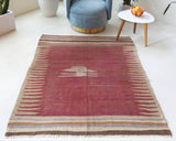Vintage kilim rug in living room setting, old rug, antique rug, pastel colors, faded colors, Turkish rug, vintage rug, soft rug, Portland, Oregon, rug store, rug shop, local shop, earthy tones, earthy colors, warm colors