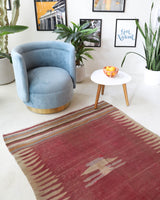 Vintage kilim rug in living room setting, old rug, antique rug, pastel colors, faded colors, Turkish rug, vintage rug, soft rug, Portland, Oregon, rug store, rug shop, local shop, earthy tones, earthy colors, warm colors