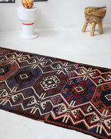 Vintage Turkish runner rug in a living room setting, pile rug, Turkish rug, vintage rug, portland, rug shop, bright colors, wild shaman, soft rug, bold color, Portland, Oregon, rug store, rug shop, local shop, antique rug