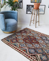 Vintage kilim rug in room decor setting, old rug, antique rug, pastel colors, faded colors, Turkish rug, vintage rug, soft rug, Portland, Oregon, rug store, rug shop, local shop, bold colors, bright colors, faded colors