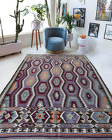 Vintage kilim rug in living room setting, old rug, antique rug, pastel colors, faded colors, Turkish rug, vintage rug, soft rug, Portland, Oregon, rug store, rug shop, local shop, earthy tones, earthy colors, warm colors