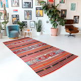 Vintage kilim rug in room decor setting, old rug, antique rug, pastel colors, faded colors, Turkish rug, vintage rug, soft rug, Portland, Oregon, rug store, rug shop, local shop, bold colors, bright colors,