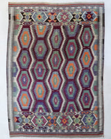 Vintage kilim rug in living room setting, old rug, antique rug, pastel colors, faded colors, Turkish rug, vintage rug, soft rug, Portland, Oregon, rug store, rug shop, local shop, earthy tones, earthy colors, warm colors