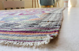 Vintage kilim rug in living room setting, old rug, antique rug, pastel colors, faded colors, Turkish rug, vintage rug, soft rug, Portland, Oregon, rug store, rug shop, local shop, earthy tones, earthy colors, warm colors