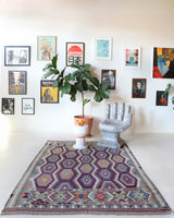 Vintage kilim rug in living room setting, old rug, antique rug, pastel colors, faded colors, Turkish rug, vintage rug, soft rug, Portland, Oregon, rug store, rug shop, local shop, earthy tones, earthy colors, warm colors