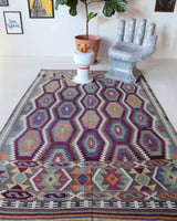 Vintage kilim rug in living room setting, old rug, antique rug, pastel colors, faded colors, Turkish rug, vintage rug, soft rug, Portland, Oregon, rug store, rug shop, local shop, earthy tones, earthy colors, warm colors