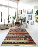 Vintage kilim rug in room decor setting, old rug, antique rug, pastel colors, faded colors, Turkish rug, vintage rug, soft rug, Portland, Oregon, rug store, rug shop, local shop, bold colors, bright colors, faded colors