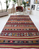 Vintage kilim rug in room decor setting, old rug, antique rug, pastel colors, faded colors, Turkish rug, vintage rug, soft rug, Portland, Oregon, rug store, rug shop, local shop, bold colors, bright colors, faded colors