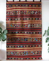 Vintage kilim rug in room decor setting, old rug, antique rug, pastel colors, faded colors, Turkish rug, vintage rug, soft rug, Portland, Oregon, rug store, rug shop, local shop, bold colors, bright colors, faded colors