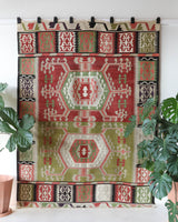 Vintage kilim rug in living room setting, old rug, antique rug, pastel colors, faded colors, Turkish rug, vintage rug, soft rug, Portland, Oregon, rug store, rug shop, local shop, earthy tones, earthy colors, warm colors