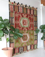 Vintage kilim rug in living room setting, old rug, antique rug, pastel colors, faded colors, Turkish rug, vintage rug, soft rug, Portland, Oregon, rug store, rug shop, local shop, earthy tones, earthy colors, warm colors