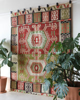 Vintage kilim rug in living room setting, old rug, antique rug, pastel colors, faded colors, Turkish rug, vintage rug, soft rug, Portland, Oregon, rug store, rug shop, local shop, earthy tones, earthy colors, warm colors