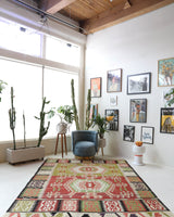 Vintage kilim rug in living room setting, old rug, antique rug, pastel colors, faded colors, Turkish rug, vintage rug, soft rug, Portland, Oregon, rug store, rug shop, local shop, earthy tones, earthy colors, warm colors