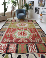 Vintage kilim rug in living room setting, old rug, antique rug, pastel colors, faded colors, Turkish rug, vintage rug, soft rug, Portland, Oregon, rug store, rug shop, local shop, earthy tones, earthy colors, warm colors