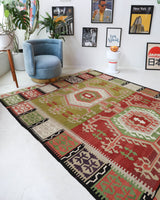 Vintage kilim rug in living room setting, old rug, antique rug, pastel colors, faded colors, Turkish rug, vintage rug, soft rug, Portland, Oregon, rug store, rug shop, local shop, earthy tones, earthy colors, warm colors