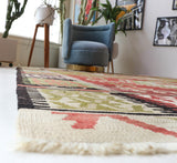 Vintage kilim rug in living room setting, old rug, antique rug, pastel colors, faded colors, Turkish rug, vintage rug, soft rug, Portland, Oregon, rug store, rug shop, local shop, earthy tones, earthy colors, warm colors