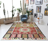 Vintage kilim rug in living room setting, old rug, antique rug, pastel colors, faded colors, Turkish rug, vintage rug, soft rug, Portland, Oregon, rug store, rug shop, local shop, earthy tones, earthy colors, warm colors