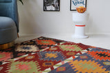 Vintage kilim rug in living room setting, bright colors, wild shaman, soft rug, bold color, Portland, Oregon, rug store, rug shop, local shop, vintage rug, modern kilim, warm colors