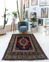 Antique Turkish rug in a living room setting, pile rug, Turkish rug, vintage rug, portland, rug shop, bright colors, wild shaman, soft rug, bold color, Portland, Oregon, rug store, rug shop, local shop, antique rug