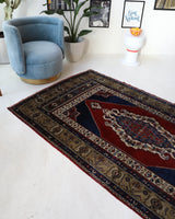 Antique Turkish rug in a living room setting, pile rug, Turkish rug, vintage rug, portland, rug shop, bright colors, wild shaman, soft rug, bold color, Portland, Oregon, rug store, rug shop, local shop, antique rug