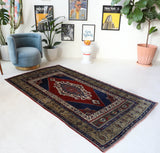 Antique Turkish rug in a living room setting, pile rug, Turkish rug, vintage rug, portland, rug shop, bright colors, wild shaman, soft rug, bold color, Portland, Oregon, rug store, rug shop, local shop, antique rug
