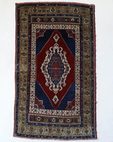 Antique Turkish rug in a living room setting, pile rug, Turkish rug, vintage rug, portland, rug shop, bright colors, wild shaman, soft rug, bold color, Portland, Oregon, rug store, rug shop, local shop, antique rug