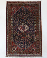Antique Persian rug in a living room setting, pile rug, vintage rug, portland, rug shop, bright colors, wild shaman, soft rug, bold color, Portland, Oregon, rug store, rug shop, local shop, antique rug, Persian rug, handmade rug, wool rug, distressed rug