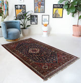 Antique Persian  rug in a living room setting, pile rug, vintage rug, portland, rug shop, bright colors, wild shaman, soft rug, bold color, Portland, Oregon, rug store, rug shop, local shop, antique rug, Persian rug, handmade rug, wool rug, distressed rug