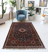 Antique Persian  rug in a living room setting, pile rug, vintage rug, portland, rug shop, bright colors, wild shaman, soft rug, bold color, Portland, Oregon, rug store, rug shop, local shop, antique rug, Persian rug, handmade rug, wool rug, distressed rug