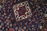Antique Persian  rug in a living room setting, pile rug, vintage rug, portland, rug shop, bright colors, wild shaman, soft rug, bold color, Portland, Oregon, rug store, rug shop, local shop, antique rug, Persian rug, handmade rug, wool rug, distressed rug