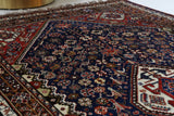 Antique Persian  rug in a living room setting, pile rug, vintage rug, portland, rug shop, bright colors, wild shaman, soft rug, bold color, Portland, Oregon, rug store, rug shop, local shop, antique rug, Persian rug, handmade rug, wool rug, distressed rug