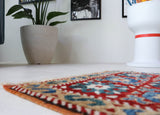 Vintage Turkish rug in a living room setting, pile rug, Turkish rug, vintage rug, portland, rug shop, bright colors, wild shaman, soft rug, bold color, Portland, Oregon, rug store, rug shop, local shop, antique rug
