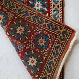 Vintage Turkish rug in a living room setting, pile rug, Turkish rug, vintage rug, portland, rug shop, bright colors, wild shaman, soft rug, bold color, Portland, Oregon, rug store, rug shop, local shop, antique rug