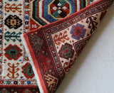 Vintage Turkish rug in a living room setting, pile rug, Turkish rug, vintage rug, portland, rug shop, bright colors, wild shaman, soft rug, bold color, Portland, Oregon, rug store, rug shop, local shop, antique rug