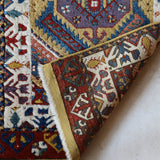 Vintage Turkish rug in a living room setting, pile rug, Turkish rug, vintage rug, portland, rug shop, bright colors, wild shaman, soft rug, bold color, Portland, Oregon, rug store, rug shop, local shop, antique rug