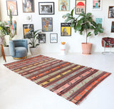 Vintage kilim rug in room decor setting, old rug, antique rug, pastel colors, faded colors, Turkish rug, vintage rug, soft rug, Portland, Oregon, rug store, rug shop, local shop, bold colors, bright colors, faded colors