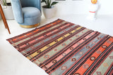 Vintage kilim rug in room decor setting, old rug, antique rug, pastel colors, faded colors, Turkish rug, vintage rug, soft rug, Portland, Oregon, rug store, rug shop, local shop, bold colors, bright colors, faded colors