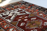 Vintage Turkish rug in a living room setting, pile rug, Turkish rug, vintage rug, portland, rug shop, bright colors, wild shaman, soft rug, bold color, Portland, Oregon, rug store, rug shop, local shop, antique rug