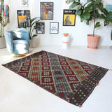 Vintage kilim rug in room decor setting, old rug, antique rug, pastel colors, faded colors, Turkish rug, vintage rug, soft rug, Portland, Oregon, rug store, rug shop, local shop, bold colors, bright colors, faded colors