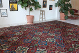 Antique Persian area rug in a living room setting, pile rug, vintage rug, portland, rug shop, bright colors, wild shaman, soft rug, bold color, Portland, Oregon, rug store, rug shop, local shop, antique rug, Persian rug, handmade rug, wool rug, distressed rug