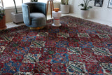 Antique Persian area rug in a living room setting, pile rug, vintage rug, portland, rug shop, bright colors, wild shaman, soft rug, bold color, Portland, Oregon, rug store, rug shop, local shop, antique rug, Persian rug, handmade rug, wool rug, distressed rug